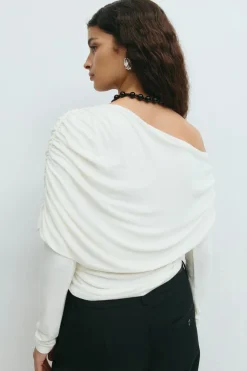 Sloped shoulder cape top