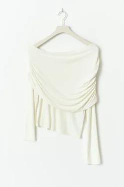 Sloped shoulder cape top